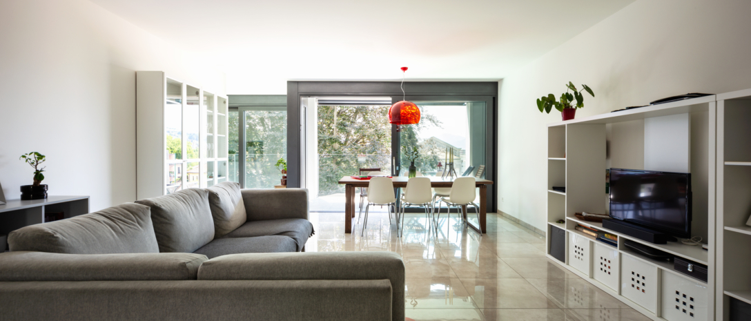 Living room with large designer sofa in modern apartment